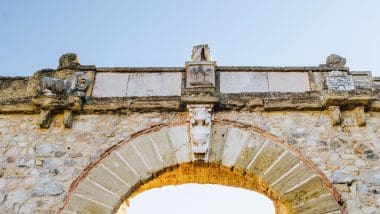 a stone arch with stone carvings, Antequera